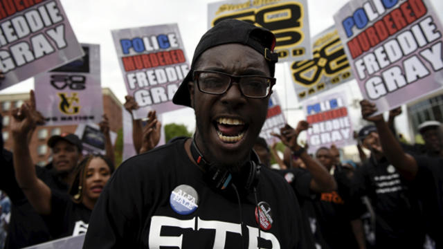 A man shouts slogans during a protest at the intersection of W North and Pennsylvania Avenues in Baltimore May 1, 2015. 