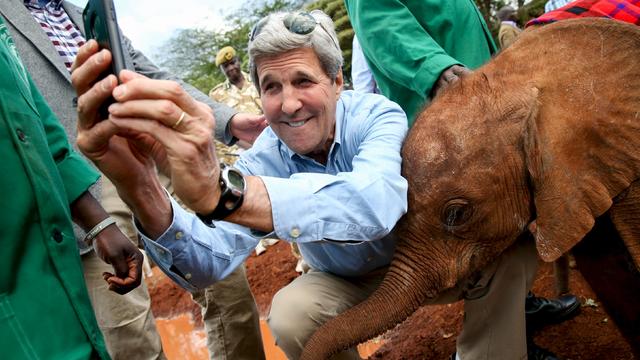 U.S. Secretary of State John Kerry takes a selfie with a baby elephant while touring the Sheldrick Center Elephant Orphanage 