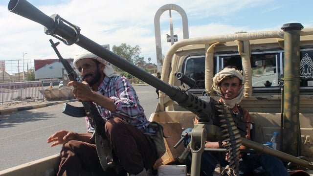 Armed Yemeni tribal gunmen of the Popular Resistance Committees loyal to fugitive President Abedrabbo Mansour Hadi, sit on a pick up truck mounted with a machine gun.jpg 
