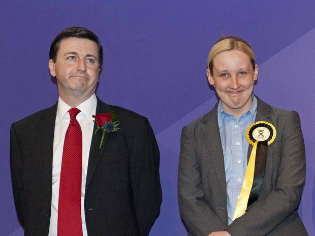 Newly elected Scottish National Party (SNP) member of parliament, Mhairi Black (R), next to the man she ousted, Labour candidate Douglas Alexander 
