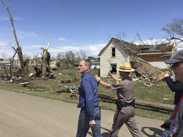 South Dakota Governor Dennis Daugaard (L) surveys damage from a tornado that touched down in Delmont, South Dakota in this handout photo 