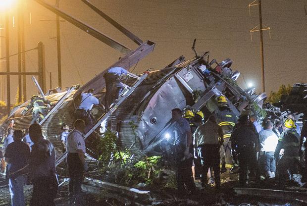Rescue workers search for victims in the wreckage of a derailed Amtrak train in Philadelphia 