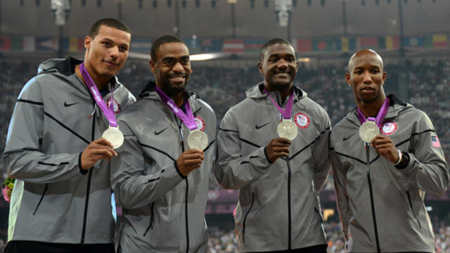 Ryan Bailey, Tyson Gay, Justin Gatlin and Trell Kimmons pose on the podium after winning the men's 4X100 relay final at the athletics event during the London 2012 Olympic Games Aug. 11, 2012, in London. 