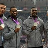 Ryan Bailey, Tyson Gay, Justin Gatlin and Trell Kimmons pose on the podium after winning the men's 4X100 relay final at the athletics event during the London 2012 Olympic Games Aug. 11, 2012, in London. 