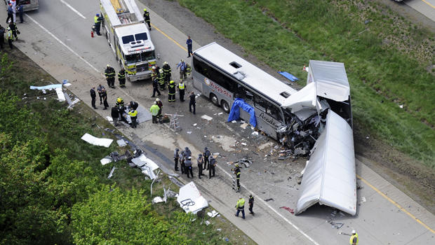 Authorities investigate the scene of a fatal collision between a tractor-trailer and a tour bus on Interstate 380 near Mount Pocono, Pa., June 3, 2015. 