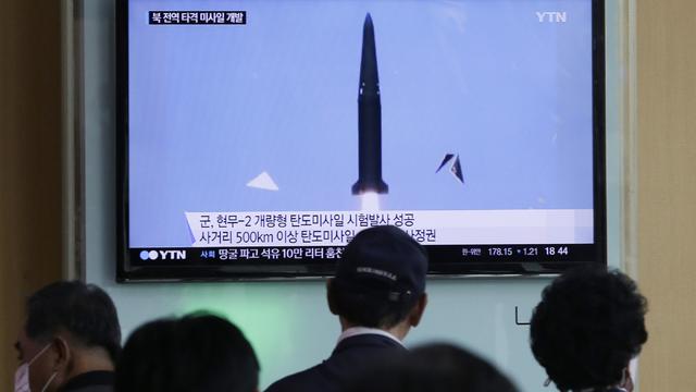 People watch a TV news program showing South Korea's missile test at Seoul Railway Station in Seoul, South Korea 