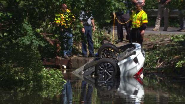An overturned car in the water in Framingham 