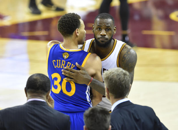 Cleveland Cavaliers' LeBron James shakes hands with Golden State Warriors' Stephen Curry during fourth quarter of Game 6 of NBA Finals at Quicken Loans Arena; Warriors won 105-97 to give them the series 4 games to 2, and the NBA crown 