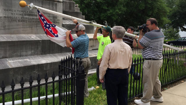State workers take down a Confederate flag on the grounds of the state Capitol June 24, 2015, in Montgomery, Ala. 