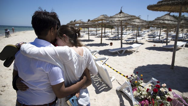 People react at the site of a shooting attack on the beach in front of the Riu Imperial Marhaba Hotel in Port el Kantaoui, on the outskirts of Sousse, Tunisia, south of the capital Tunis, June 27, 2015. 