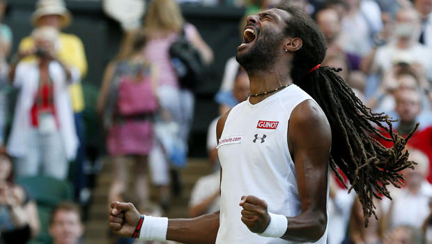Dustin Brown of Germany celebrates after winning his match against Rafael Nadal of Spain at the Wimbledon Tennis Championships in London July 2, 2015. 