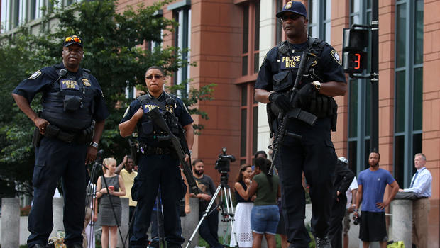 Law enforcement officials secure M Street in front of the Navy Yard facility where there was a report of shots fired July 2, 2015, in Washington. 