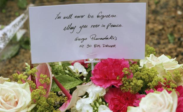 A floral tribute from bus driver George Psaradakis rests at Tavistock Square, the location where the number 30 bus driven by Psaradakis was blown apart in London, England 