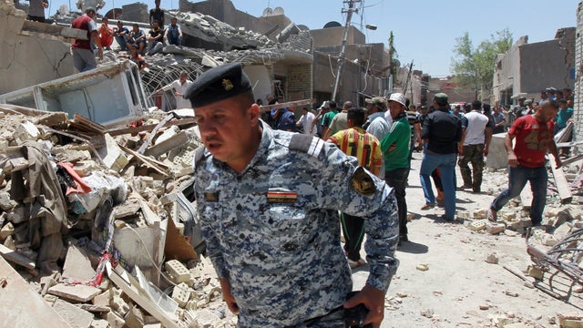 Iraqi emergency personnel inspect the aftermath of a warplane bomb accident in the al-Jadidah neighborhood east of the capital Baghdad 