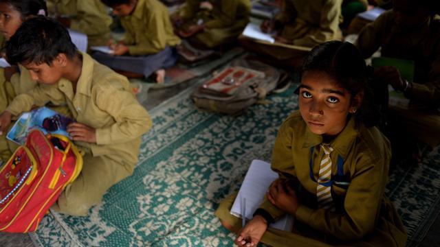 An Indian schoolgirl sits in a classroom at the Chaumuha Primary School on the outskirts of Vrindavan 