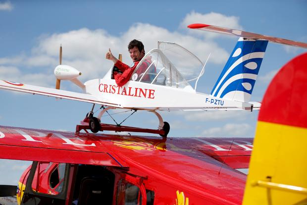 Pilot Hugues Duval in his twin-engined "Cri-Cri", one of the world's smallest electrical planes, waits to take off from an old Broussard aircraft, on which it is attached to, during a flying display at the 51st Paris Air Show at Le Bourget airport near Paris 