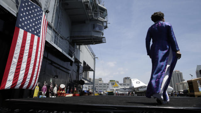 Bang Van Pham, wife of Judge Nho Trong Nguyen, walks toward the podium to speak during a commemoration event for the 40th anniversary of Operation Frequent Wind held at the USS Midway Museum in San Diego April 26, 2015. 