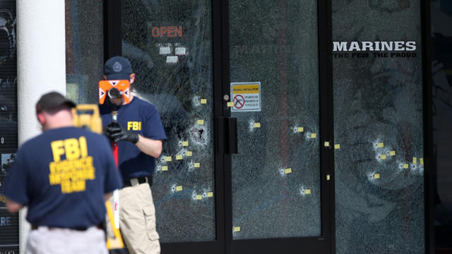 Members of the FBI Evidence Response Team investigate the shooting at the Armed Forces Career Center/National Guard Recruitment Office July 17, 2015, in Chattanooga, Tennessee. 