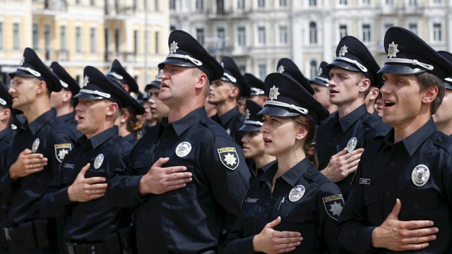 Police officers sing the national anthem during an oath-taking ceremony, which started up the work of a new police patrol service, part of the Interior Ministry reform initiated by Ukrainian authorities, in Kiev, Ukraine 