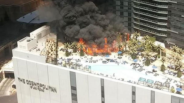 ​A fire burns on the Bamboo Pool terrace at the Cosmopolitan Hotel in Las Vegas 