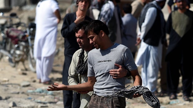 An Afghan man cries as he search for his relatives near Camp Integrity, a base housing U.S. forces that was attacked by militants in Kabul, Afghanistan, Aug. 8, 2015. 