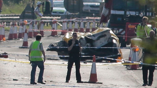 Emergency services personnel work the scene after a plane crashed into cars on a major road during an aerial display at the Shoreham Airshow in West Sussex, England, Aug. 22, 2015. 