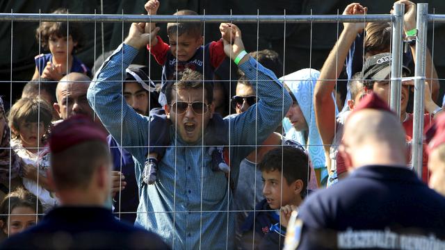 Syrian migrants shout slogans at a refugee camp in Roszke, Hungary 