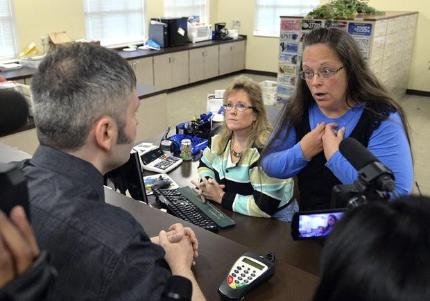 Rowan County Clerk Kim Davis, right, talks with David Moore following her office's refusal to issue marriage licenses at the Rowan County Courthouse in Morehead, Ky., Sept. 1, 2015. 
