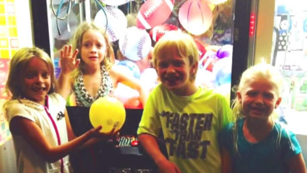 Juliette Grimes, 6, is seen trapped inside an arcade game at her local pizza parlor. 