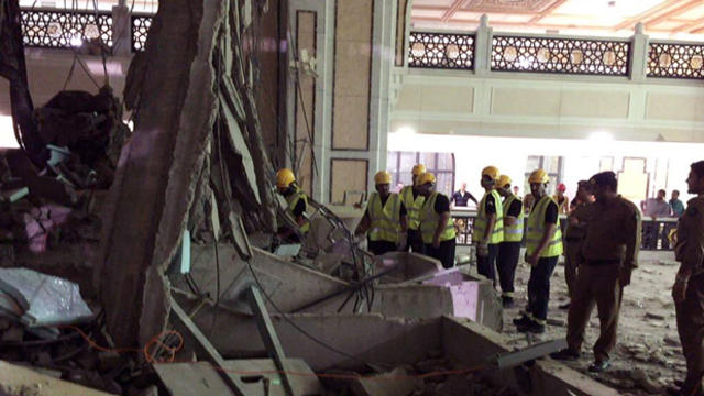 In this image released by the Saudi Interior Ministry’s General Directorate of Civil Defense, Civil Defense personnel inspect the damage at the Grand Mosque in Mecca after a crane collapsed, killing dozens, Sept. 11, 2015. 