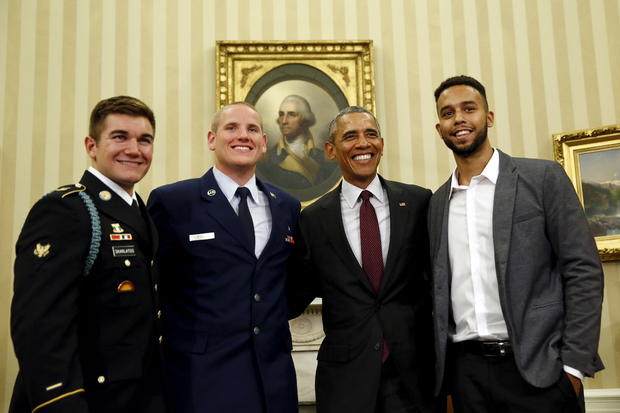 President Obama poses for pictures with Spencer Stone, 2nd left, Anthony Sadler, right, and Alek Skarlatos, left, the three men who subdued a gunman on a Paris-bound train in August, at the Oval Office at the White House in Washington Sept. 17, 2015. 