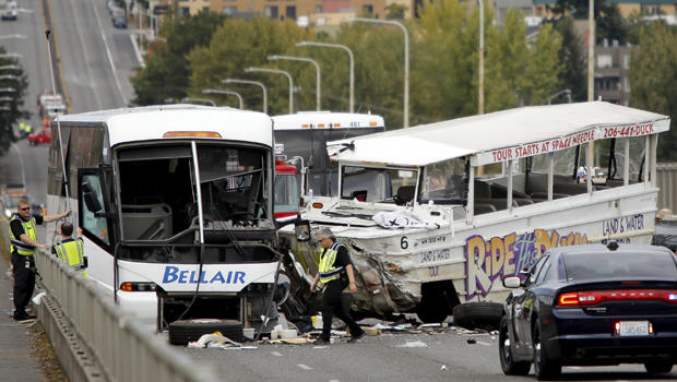 Investigators are pictured at the scene of a crash between a Ride the Ducks vehicle and a charter bus on the Aurora Avenue bridge in Seattle, Washington, Sept. 24, 2015. 