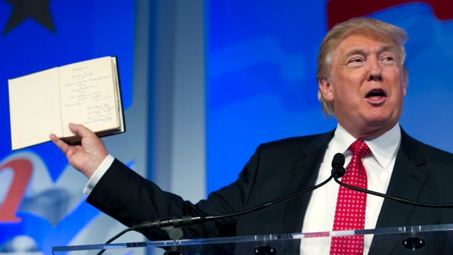 Republican presidential candidate, businessman Donald Trump holds up a Bible that was given to him by his mother as he speaks during the Values Voter Summit, held by the Family Research Council, Sept. 25, 2015, in Washington. 