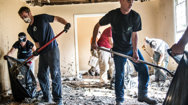 Volunteers help clean up a home in the Gills Creek area in Columbia, South Carolina, Oct. 8, 2015. 