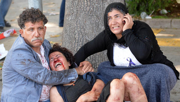 An injured woman is comforted following an explosion at the main train station in Turkey's capital of Ankara Oct. 10, 2015. 