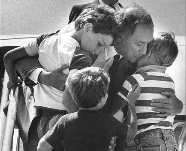 Canadian Prime Minister Pierre Trudeau greets his sons Justin (left), Sacha (right) and Michel after returning home from a foreign trip to Ottawa, in a 1983 file photo 