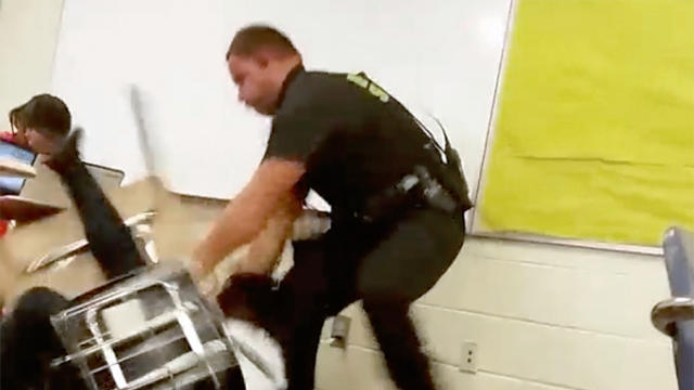 Senior Deputy Ben Fields tries to forcibly remove a student who refused to leave her math class at Spring Valley High School in Columbia, S.C., in this Oct. 26, 2015, image from cellphone video. 