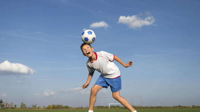 kid-heading-soccer-ball.jpg 