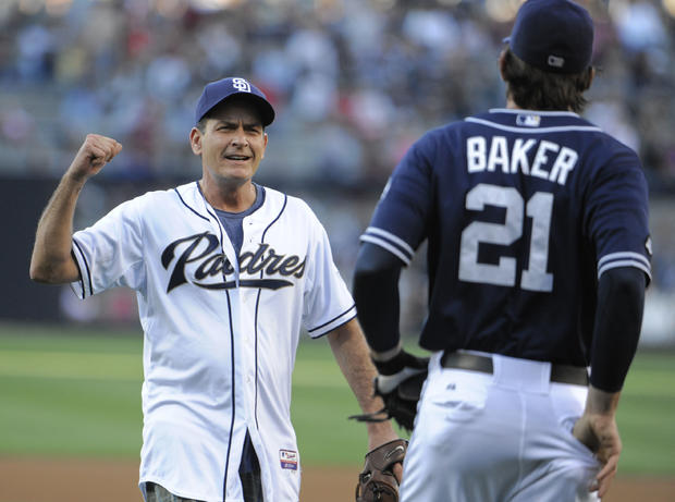 SAN DIEGO, CA - JULY 7:  Actor Charlie Sheen greets John Baker #21 of the San Diego Padres after throwing out the first pitch before a baseball game against the Cincinnati Reds at Petco Park on July 7, 2012 in San Diego, California. 