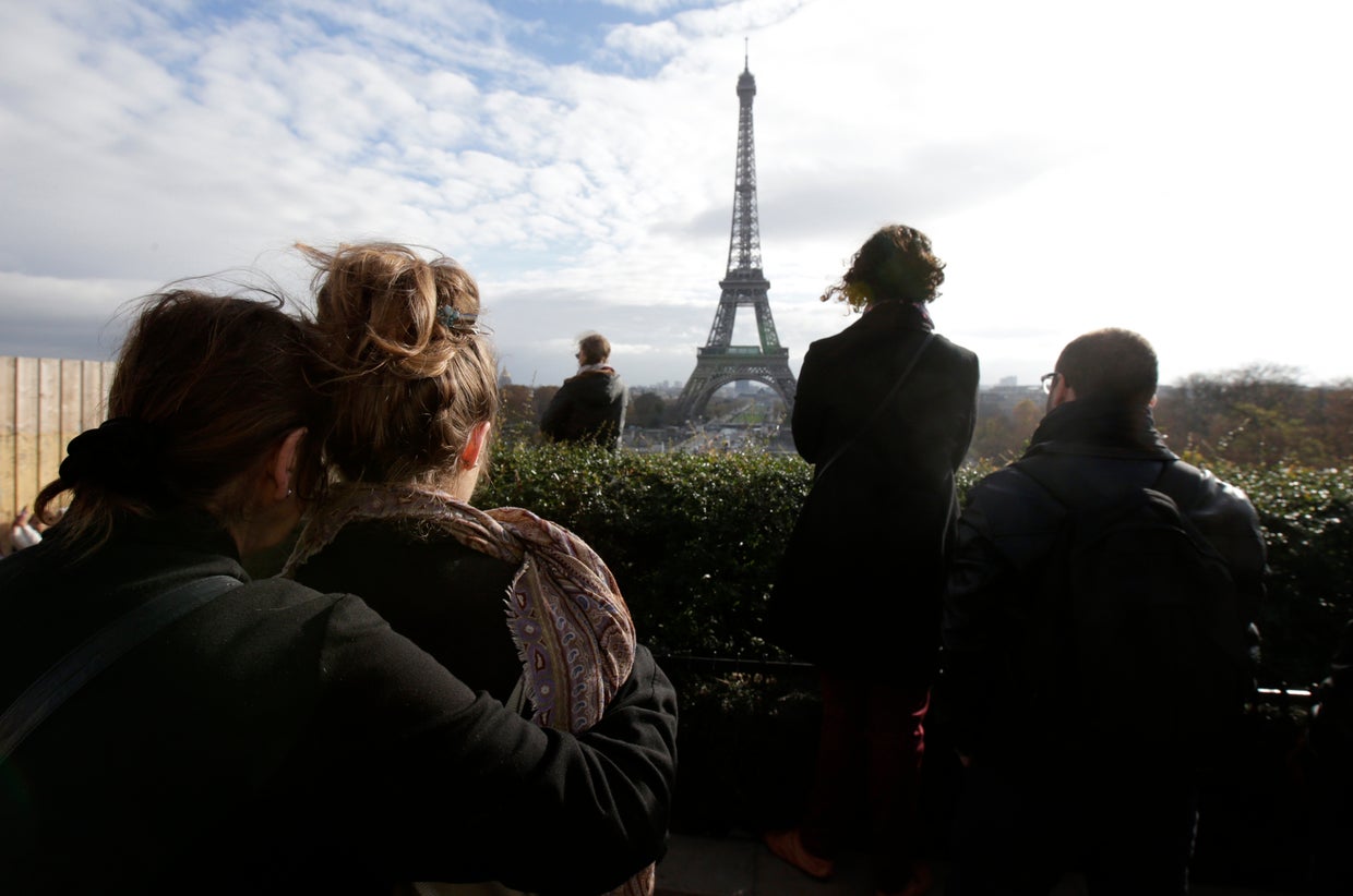 People observe a minute of silence at the Trocadero in front of the Eiffel Tower to pay tribute to the victims of the series of deadly attacks in Paris, France, Nov. 16, 2015. 
