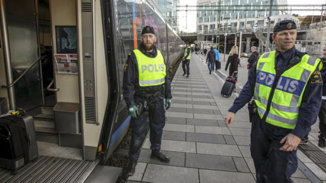 Police prepare to check an incoming train at the Swedish end of the bridge between Sweden and Denmark, in Hyllie district, Malmo, Nov. 12, 2015. 