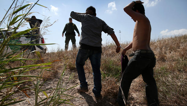 U.S. Border Patrol agents detain undocumented immigrants after they crossed the border from Mexico into the United States Aug. 7, 2015, in McAllen, Texas. 