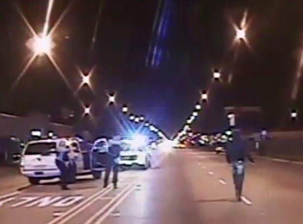 ​Laquan McDonald, right, walks on a road before he was shot 16 times by police officer Jason Van Dyke in Chicago in this still image taken from a police vehicle dash camera video shot on Oct. 20, 2014, and released by Chicago police on Nov. 24, 2015. 