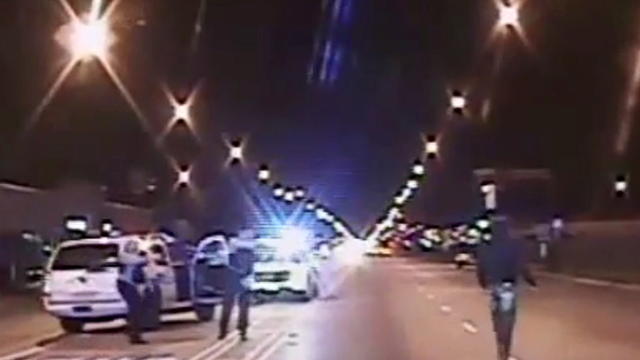 ​Laquan McDonald, right, walks on a road before he was shot 16 times by police officer Jason Van Dyke in Chicago in this still image taken from a police vehicle dash camera video shot on Oct. 20, 2014, and released by Chicago police on Nov. 24, 2015. 