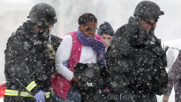 ​A woman is evacuated from a building where a shooter was holed up in Colorado Springs, Colorado, Nov. 27, 2015, during a snowstorm. 