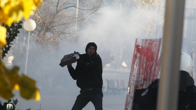 A protester supporting the opposition clashes with police in Kosovo's capital Pristina 