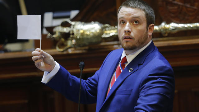 South Carolina state Rep. Christopher Corley, R-Aiken, shows his frustration by waving a white flag of surrender during debate over a Senate bill calling for the Confederate flag to be removed from the Capitol grounds July 8, 2015, in Columbia, S.C. 