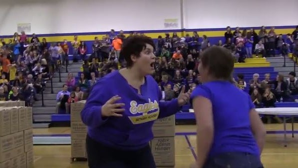 ​Angela Ramey reacts after sinking a half-court shot to win half-off tuition for her daughter at Bethany Academy in Bloomington, Minn., Dec. 4, 2015. 