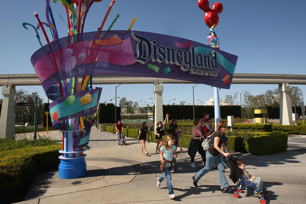 Pedestrians walk near the entrance to Disneyland Resort 