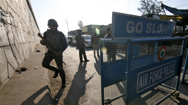 Indian security personnel stand guard next to a barricade outside the Indian air force base at Pathankot in Punjab, India, Jan. 2, 2016. 